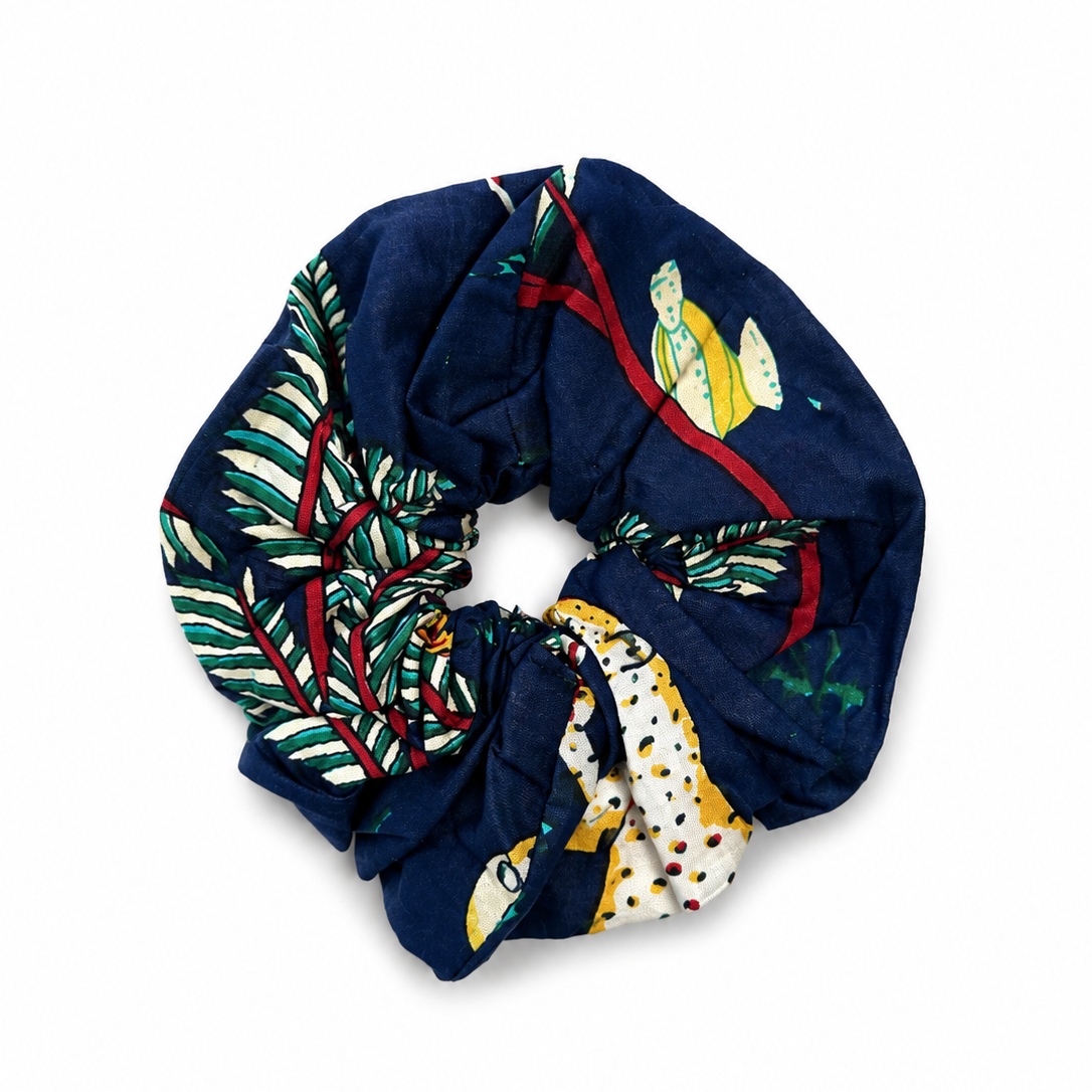 Navy blue scrunchie with colorful patterns on a white background